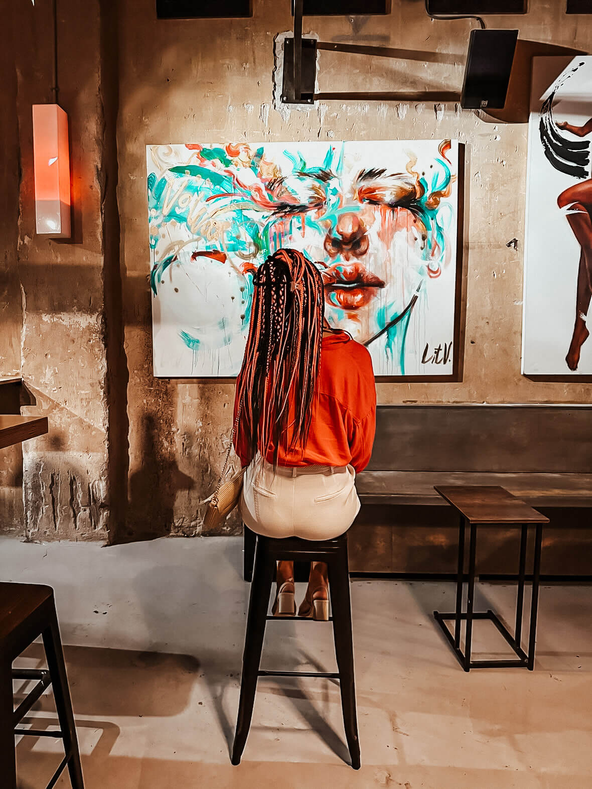 young-woman-looking-on-a-painting